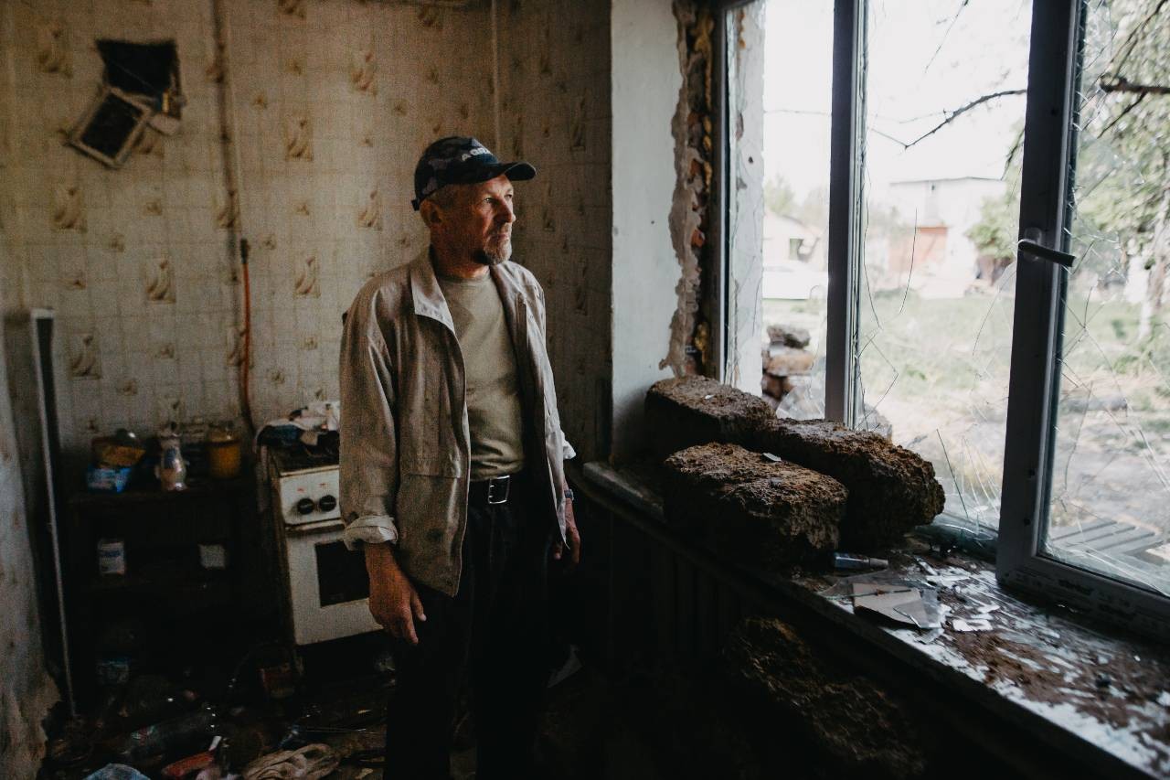 A man surveys the damage to his home in Ukraine