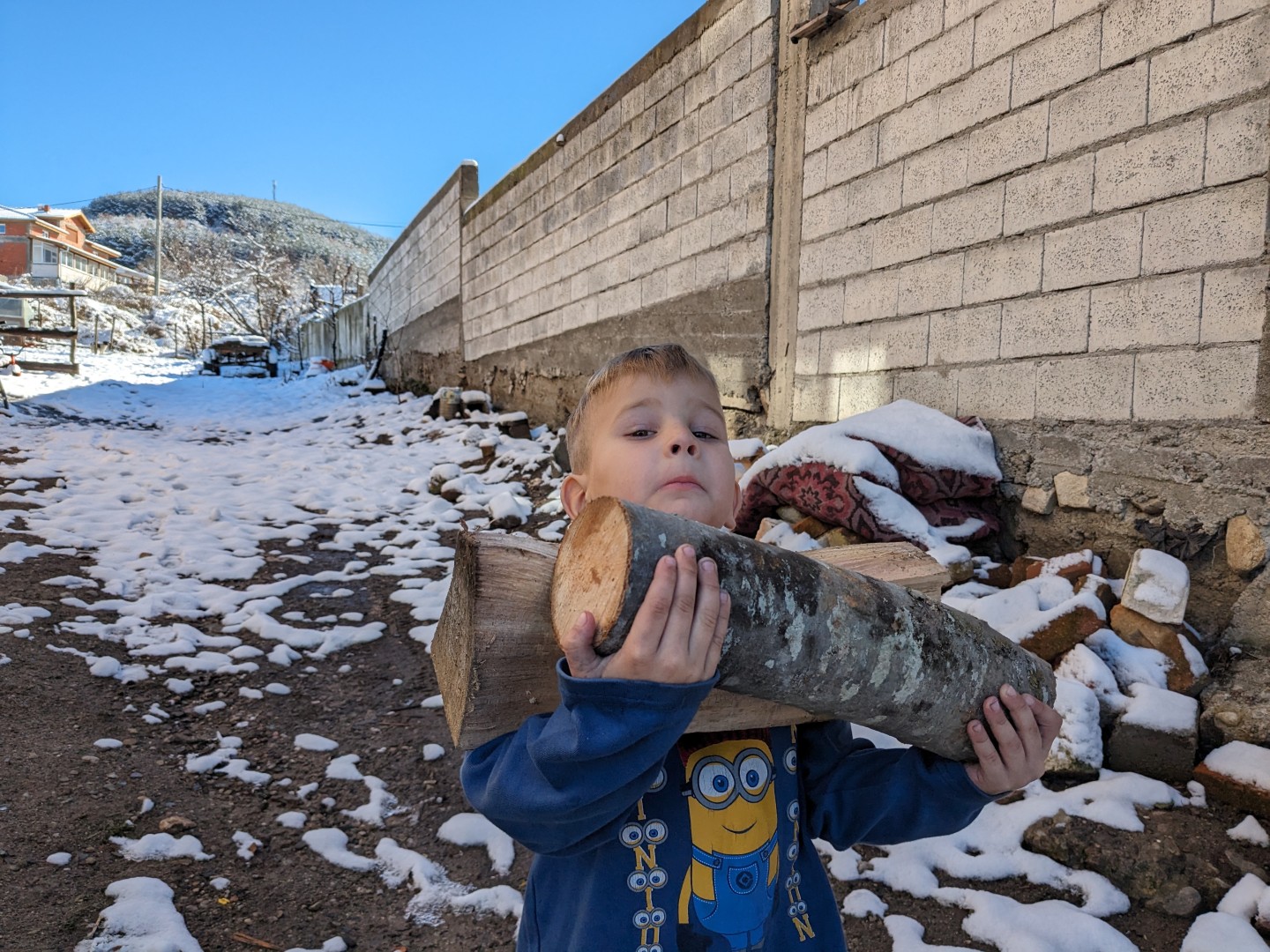 Erhan helps collect firewood to help heat his family's home