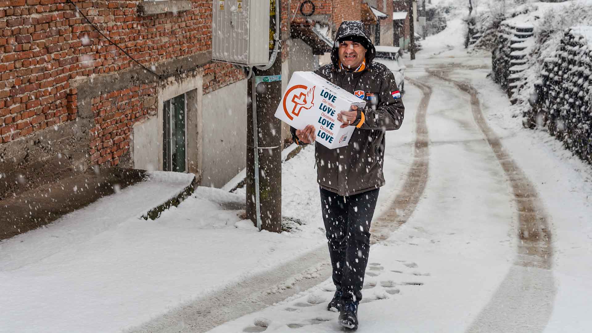 Delivering a box of supplies in the snow.