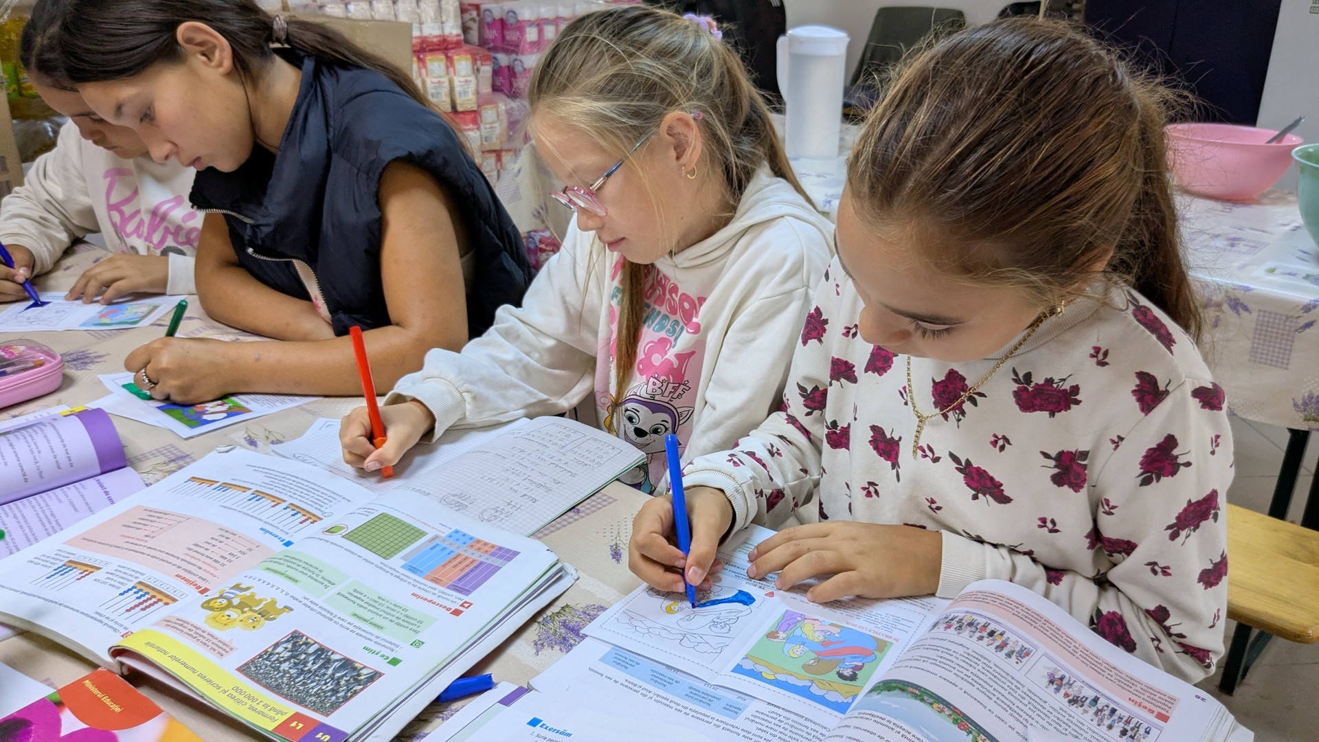 Four girls sitting at a table doing homework