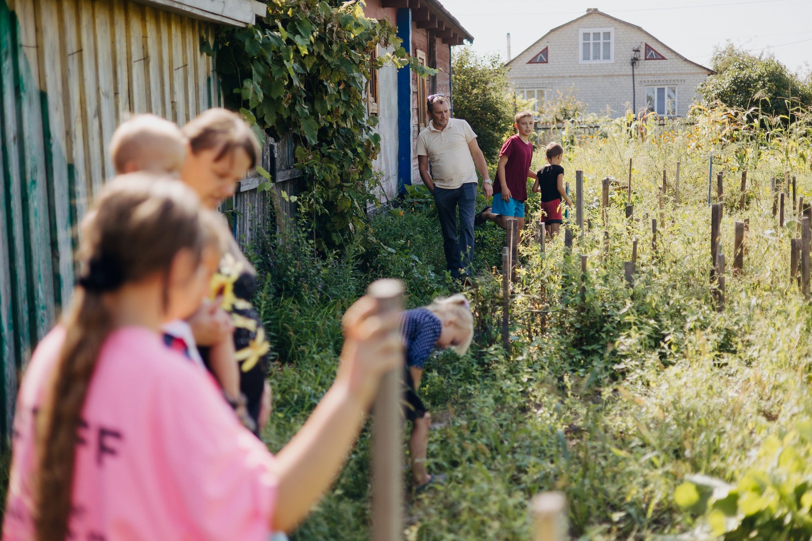 A family of 6 looking at their growing crop