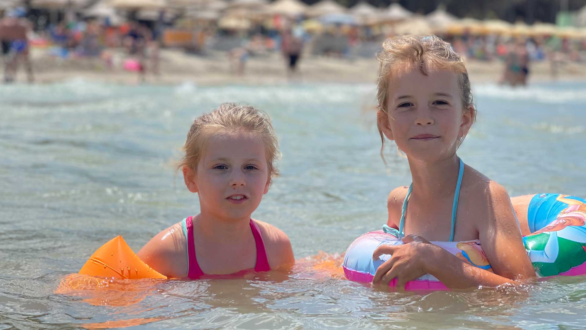 Children enjoy swimming at the beach.